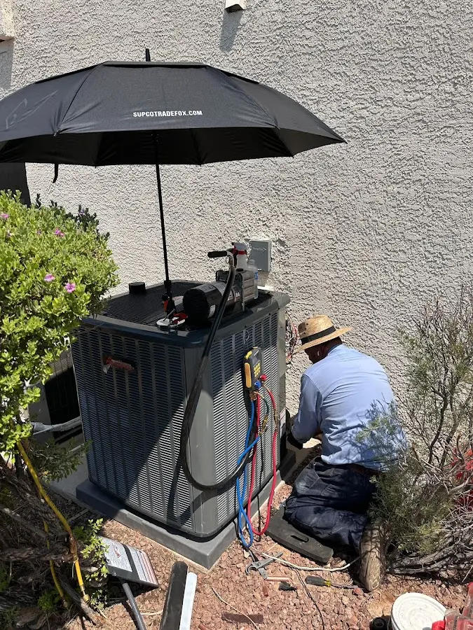 HVAC technician performing outdoor AC maintenance in Terrell